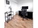 A home office featuring vinyl floors, a desk, a chair, and a shelving unit at 357 Saturn Pl, Lone Tree, CO 80124