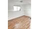 This room boasts wood-look flooring, base trim, and a bright window at 357 Saturn Pl, Lone Tree, CO 80124