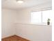 This room features wood-look flooring, a bright window, and decorative trim at 357 Saturn Pl, Lone Tree, CO 80124