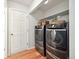 Laundry room with washer, dryer, and built-in shelving at 11292 Main Range Trl, Littleton, CO 80127