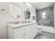 Modern bathroom featuring granite countertops and sleek gray tile at 932 Quentin St, Aurora, CO 80011