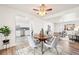 Bright dining area with a wooden table, gray chairs, and easy access to the kitchen and living room at 932 Quentin St, Aurora, CO 80011