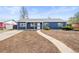 Charming blue home exterior with a walkway to the front door and potential for landscaping at 932 Quentin St, Aurora, CO 80011