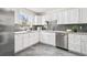 Well-lit kitchen with white cabinetry, granite countertops, and stainless steel appliances at 932 Quentin St, Aurora, CO 80011