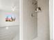 Modern shower with gray tile surround and convenient shelf at 932 Quentin St, Aurora, CO 80011