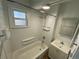 Clean bathroom with a shower/tub combo and vanity at 504 Quitman St, Denver, CO 80204