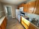 Updated kitchen with wood cabinets and white appliances at 504 Quitman St, Denver, CO 80204