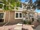 Charming townhome exterior with brick facade and a well-maintained front yard with rock covering at 7604 S Steele St, Centennial, CO 80122