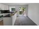 Bright kitchen features white cabinets, modern appliances, breakfast bar, and sliding doors to the outside at 7604 S Steele St, Centennial, CO 80122