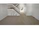 Spacious living room with a staircase and neutral carpeting, offering a blank canvas for personalization at 7604 S Steele St, Centennial, CO 80122