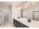 Modern bathroom with double vanity and large shower at 9637 Browns Peak Cir, Littleton, CO 80125