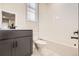 Clean bathroom with dark vanity, white tile, and bathtub at 9637 Browns Peak Cir, Littleton, CO 80125