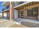 Townhome entrance with brick facade and covered walkway at 9637 Browns Peak Cir, Littleton, CO 80125