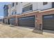Attached garage with dark brown doors and EV charger at 9637 Browns Peak Cir, Littleton, CO 80125