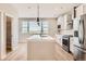 Modern kitchen with island, stainless steel appliances, and white cabinets at 9637 Browns Peak Cir, Littleton, CO 80125