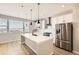 Modern kitchen with island, stainless steel appliances, and white cabinets at 9637 Browns Peak Cir, Littleton, CO 80125