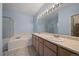 Bathroom featuring double vanity, soaking tub, and separate shower with tile surround at 6689 Kendrick Dr, Arvada, CO 80007