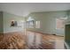 Spacious living room with gleaming hardwood floors, a vaulted ceiling, and large windows bringing in natural light at 6689 Kendrick Dr, Arvada, CO 80007