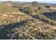 Scenic aerial view of a home nestled in a lush mountain landscape with dense forestation at 9790 City View Dr, Morrison, CO 80465