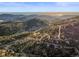 Expansive aerial view showcasing the surrounding mountains and forests, highlighting the natural beauty of the location at 9790 City View Dr, Morrison, CO 80465