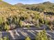 Picturesque aerial view of a charming home with mountain views and lush greenery at 9790 City View Dr, Morrison, CO 80465
