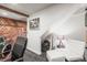 Cozy basement featuring rustic wood paneling, musical instruments, and a comfortable seating area at 9790 City View Dr, Morrison, CO 80465