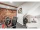 Cozy basement featuring rustic wood paneling, musical instruments, and a comfortable seating area at 9790 City View Dr, Morrison, CO 80465