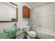 Bathroom featuring a glass bowl sink, cabinet storage, and shower tub combination at 9790 City View Dr, Morrison, CO 80465