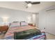 Bright bedroom with blanket, ceiling fan, and dual lamps on side tables at 9790 City View Dr, Morrison, CO 80465