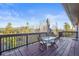 Outdoor deck with a table and chairs, offering a view of the forest and blue sky at 9790 City View Dr, Morrison, CO 80465