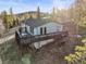 Home featuring a large wooden deck, ideal for entertaining or enjoying outdoor relaxation amid the picturesque landscape at 9790 City View Dr, Morrison, CO 80465