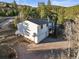 Exterior showcasing a two-story home with attached garage, basketball hoop, and ample parking on a paved driveway at 9790 City View Dr, Morrison, CO 80465