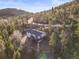 Charming home nestled in a wooded area, featuring a spacious deck perfect for enjoying the serene surroundings at 9790 City View Dr, Morrison, CO 80465