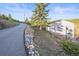 Exterior shot of a house with a tree, rock border, and an uphill driveway at 9790 City View Dr, Morrison, CO 80465