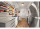 Updated kitchen featuring white cabinets, stainless steel appliances, quartz countertops, and modern lighting at 9790 City View Dr, Morrison, CO 80465