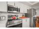 Modern kitchen boasting stainless steel appliances, bright white cabinets, and stylish countertops at 9790 City View Dr, Morrison, CO 80465