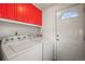 Functional laundry room with appliances, bright cabinets, and a convenient access door at 9790 City View Dr, Morrison, CO 80465