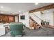 Cozy basement living room with wood paneled walls, wood-burning stove, and comfortable seating at 9790 City View Dr, Morrison, CO 80465