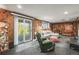 Basement living room featuring wood paneling, comfortable seating, and access to the outdoors at 9790 City View Dr, Morrison, CO 80465