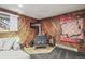 Basement area with wood paneling, tile flooring, and a cozy wood-burning stove at 9790 City View Dr, Morrison, CO 80465
