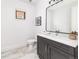 Modern bathroom with dark vanity, quartz countertop, and frameless mirror at 965 S Downing St, Denver, CO 80209