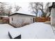 Detached garage with white brick exterior in a snowy backyard at 965 S Downing St, Denver, CO 80209