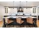 Spacious kitchen featuring a large island with seating and white and dark cabinets at 965 S Downing St, Denver, CO 80209