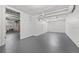 Unfinished basement with gray painted floor and white walls with storage at 2140 S Washington St, Denver, CO 80210