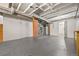 Spacious unfinished basement with exposed ceiling and brick support column at 2140 S Washington St, Denver, CO 80210