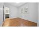 Bedroom featuring hardwood floors, natural light, and ensuite bathroom access at 2140 S Washington St, Denver, CO 80210