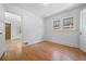 Bright bedroom with two windows and gleaming hardwood floors with an open door at 2140 S Washington St, Denver, CO 80210