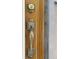 Close-up of the wood front door with decorative hardware and secure lock at 2140 S Washington St, Denver, CO 80210