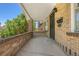 Covered front porch featuring brick columns, white ceiling, and a secure metal door at 2140 S Washington St, Denver, CO 80210