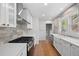 Bright kitchen featuring new appliances, white cabinetry, and stylish backsplash at 2140 S Washington St, Denver, CO 80210